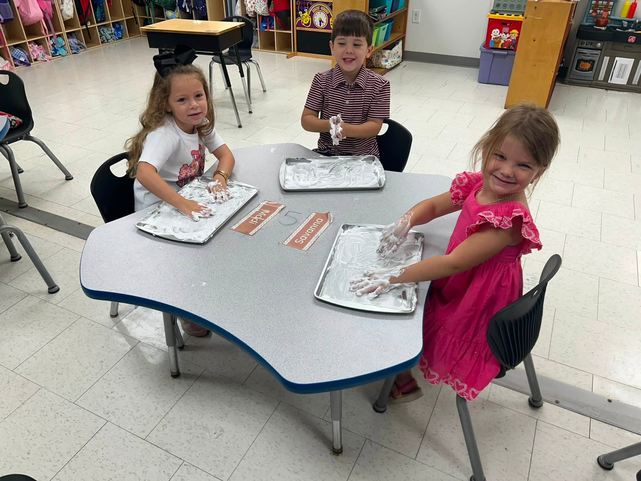 Clarendon Hall preschool students practicing letters with a sensory activity