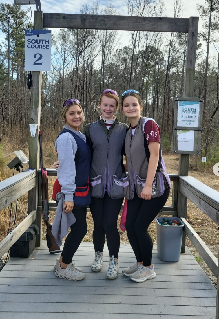 Three Clarendon Hall Sporting Clays teammates at a course station.